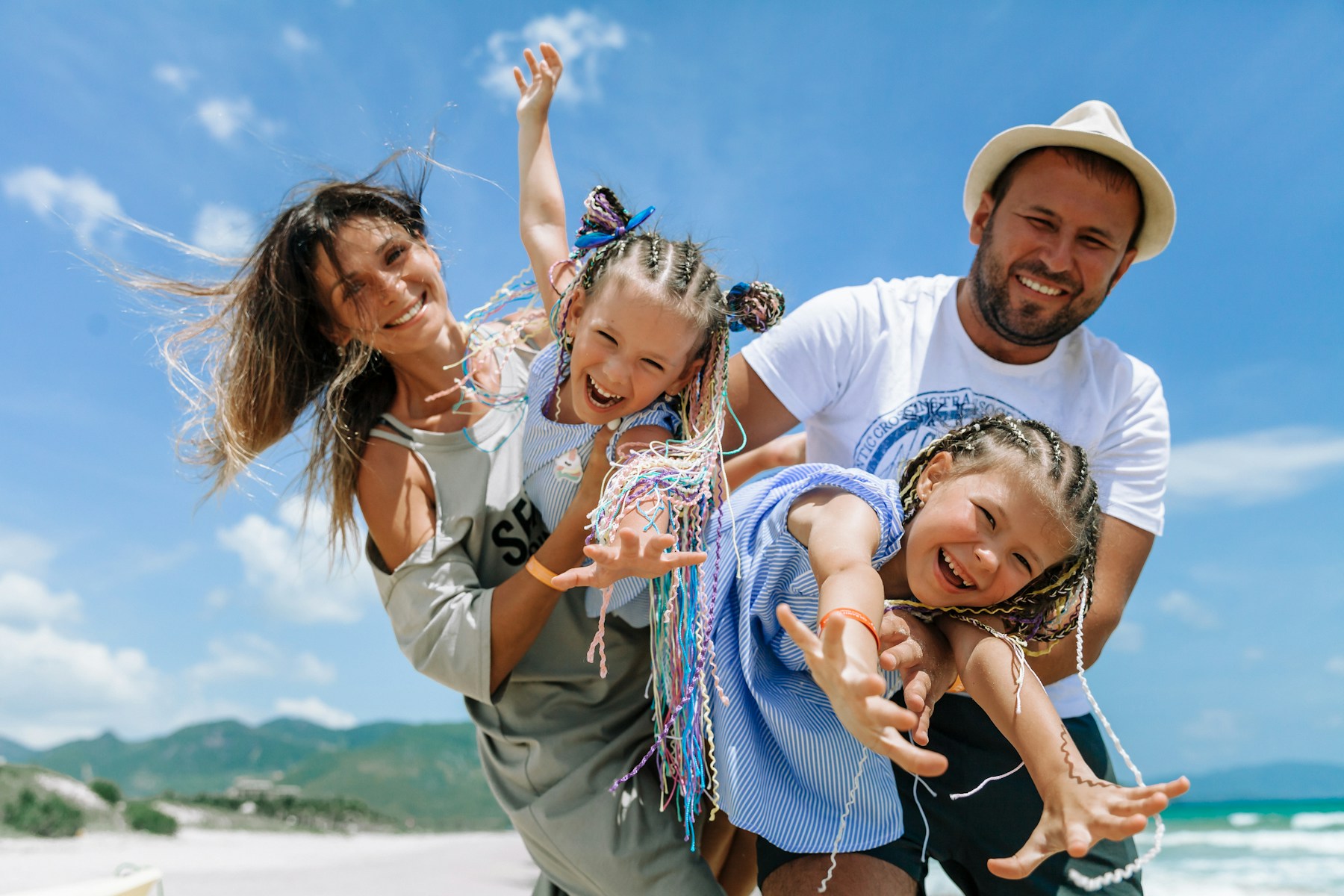 Happy parents and children enjoying a beach holiday