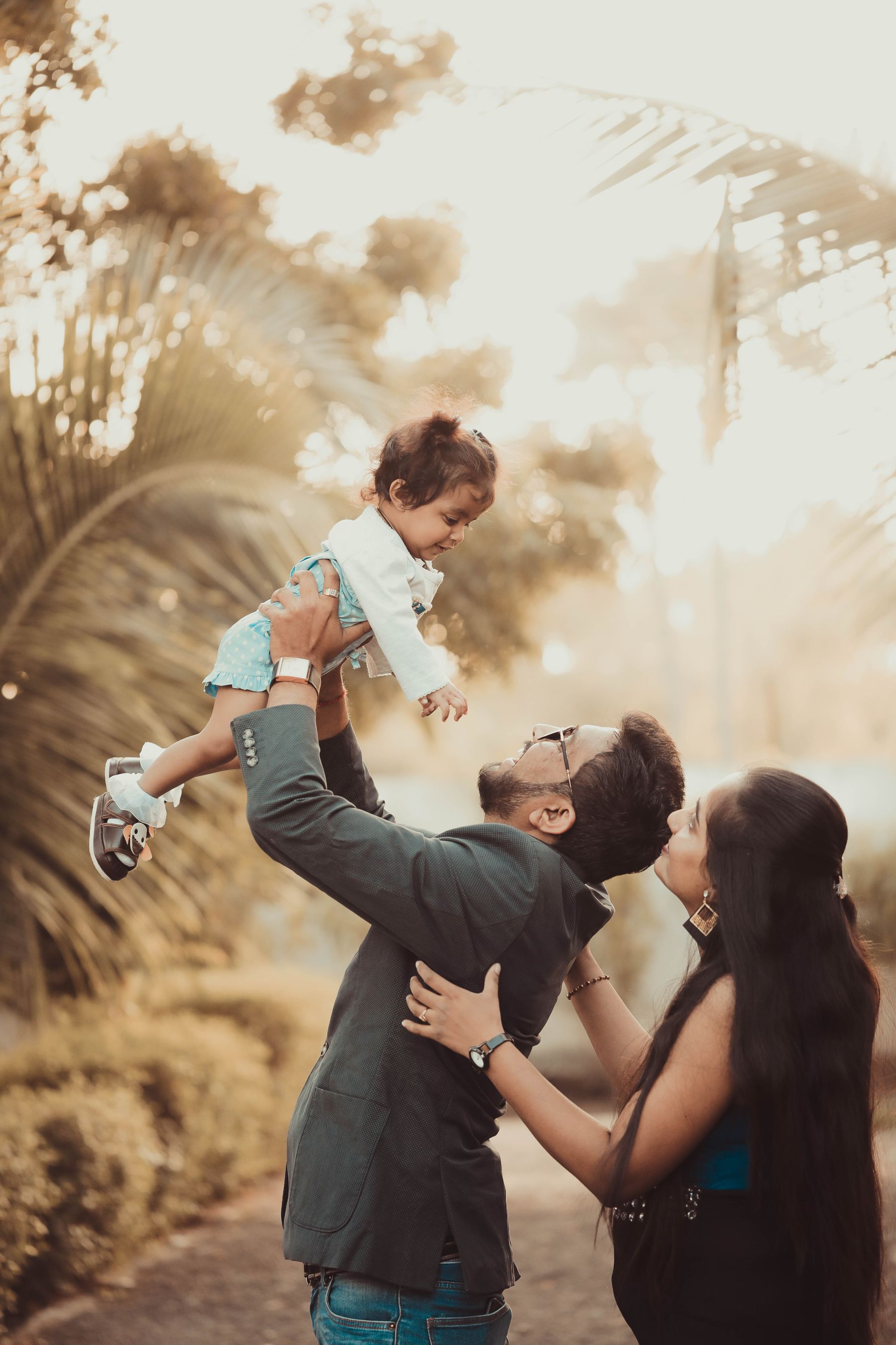 Indian parents sharing a joyful moment with their daughter