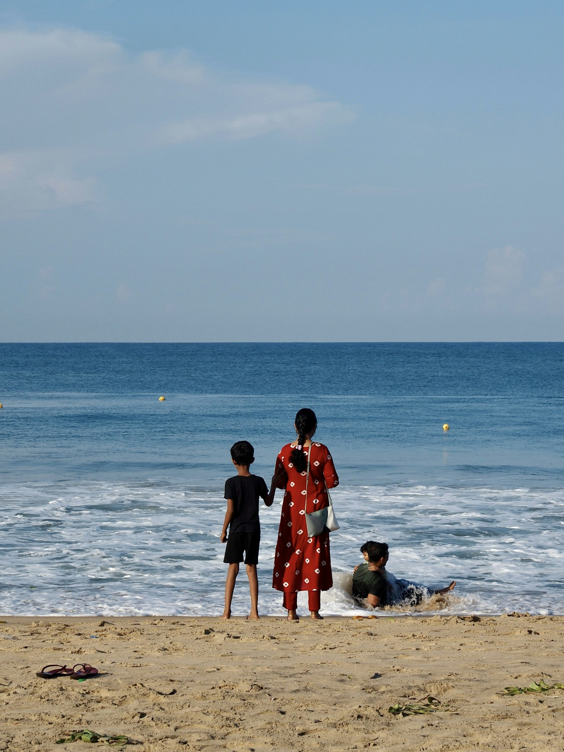 Indian mother and children enjoying a tropical beach