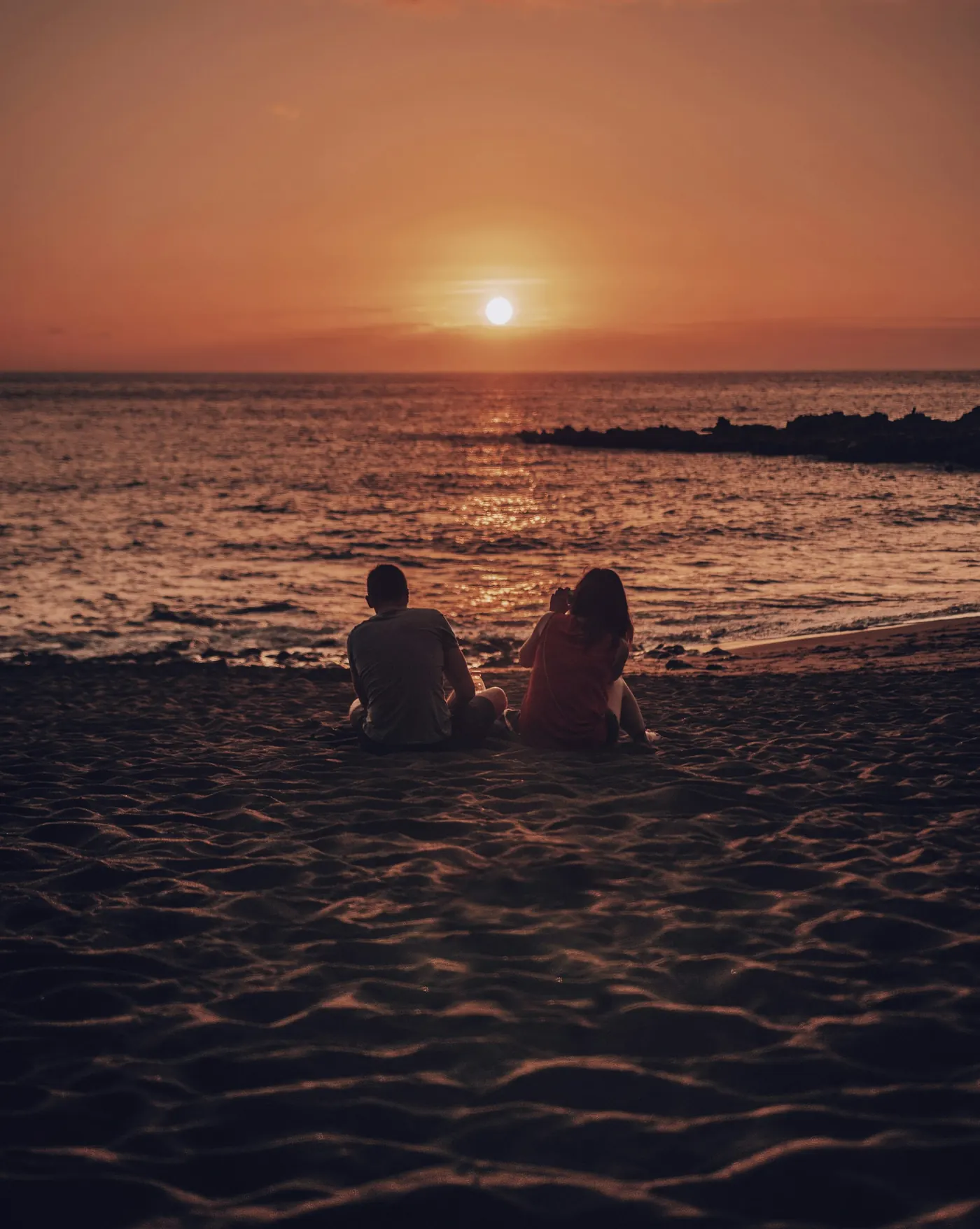 Couple enjoying a final golden Bali beach moment